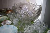 Large pressed glass punch set--bowl and base with lots of cups in various patterns.