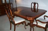 Cherry dining table with 4 chairs and 2 leaves.