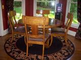 Casual dining table with four chairs, area rug.