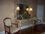 Outstanding console table and designer mirror, lamps, decorative items and pair of chairs.
