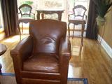 Bistro table and chairs, leather chair, area rugs.