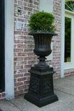 One of a pair of metal urns.