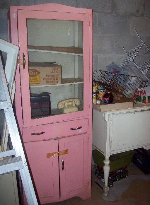 Cute vintage kitchen cupboard--pretty in pink.
