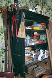 Antique cabinet filled with vintage upholstery supplies and equipment.
