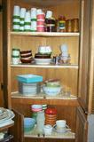 Corner kitchen cabinet filled with retro plastic and Pyrex from the 1950s-1970s.
