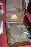 Portable crank-style record player with place to hold your favorite records, works.