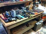Old primitive work table full of tools and more.