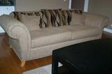 Matching sofa and loveseat with pillows.
