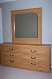 Queen-size bedroom group includes headboard, frame, box springs and mattress, dresser with mirror and 2 bedside tables.
