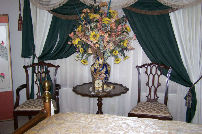 Lovely table with floral decor and two side chairs.