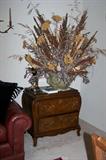 Small commode chest with floral decor.