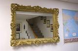 Decorative mirror in ornate frame.