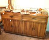 American by Martinsville vintage dining room furniture--long and slender drop leaf table with 6 chairs and buffet, maybe pecan wood.