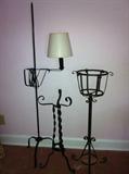 Assorted wrought iron floor lamps and plant stands.