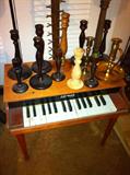 Toy piano, collection of brass and wood candle holders.