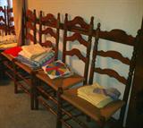 Matching set of 9 mahogany ladder back chairs with rope seats.