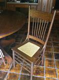 Round oak pedestal table with 4 chairs.