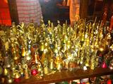 Shelf full of brass bells.