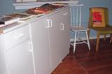 Storage cabinet, chairs, photography books.