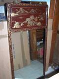 Large mirror with lacquer frame and top border.