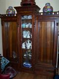 Walnut and burl 3-section bookcase. Middle door is etched glass. Several shelves in each section, two outer sections have lower drawers. Beautiful!
