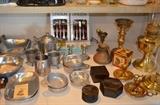 The "Metals" table Pewter - some antique, some unused, Vintage Oneida stainless flatware,. Brass - Aladdin Kerosene Lamp, unused, candlesticks, brass oil lamp, Nesting lacquer boxes.
