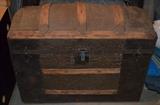 Alligator skin covers the center of this Antique trunk.