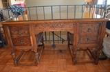 Pretty Carved wood desk, early last century.  Missing one decorative piece of molding on the lower left drawer.  Lots of good storage, extra deep drawers.