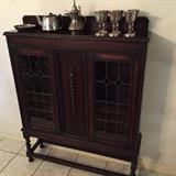 Enclosed oak bookcase with stained glass windows