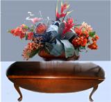 A sample of the very nice silk arrangements available. This is a Chasen Reed of Sarasota in footed copper pot. Nice drop leaf coffee table