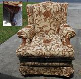 One of two Matching Wingback chairs showing a close up of one of the feet