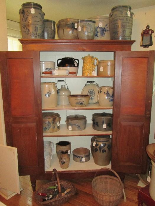 Old pie safe cabinet filled with New York, Pennsylvania salt glaze stoneware crocks, churns, cake crocks, pitchers, etc.