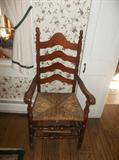 Ladder back arm chair w/ cane seat