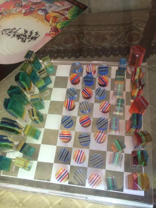 Vintage lucite chess set attributed to Charles Hollis Jones.  Also pieces for lucite checkers.  Includes original lucite box and board.