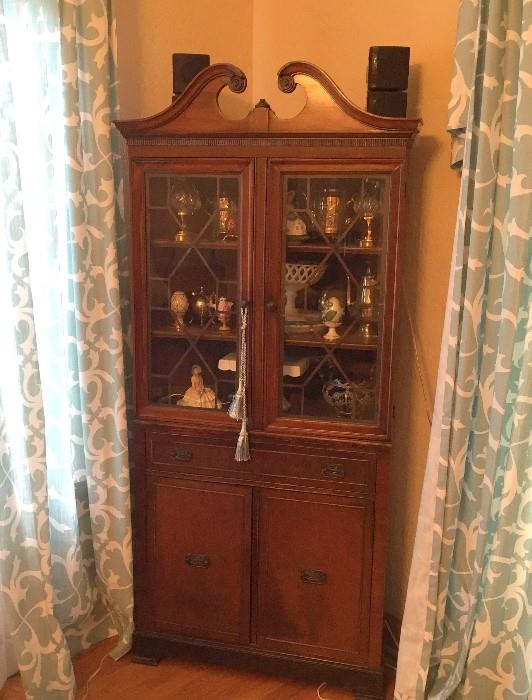 Antique corner display cabinet.
