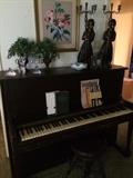 Monarch upright piano; music books; antique piano stool