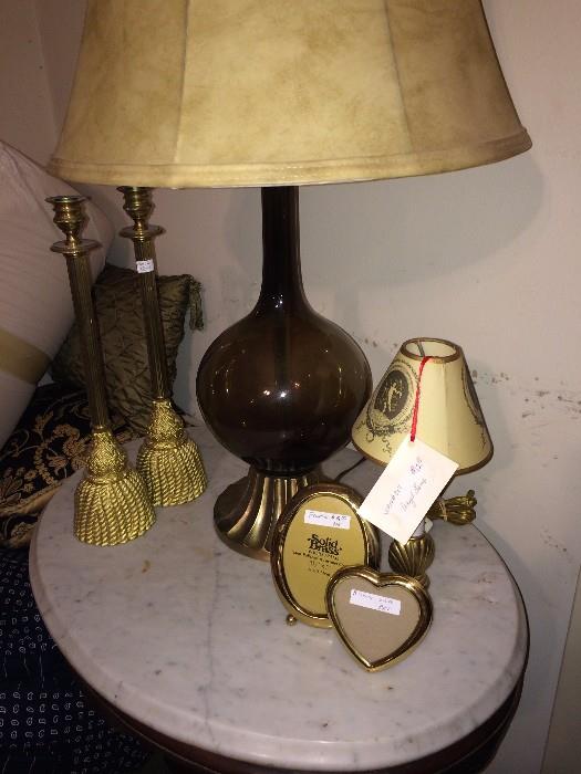 One of the lamps along with more frames on marble top table