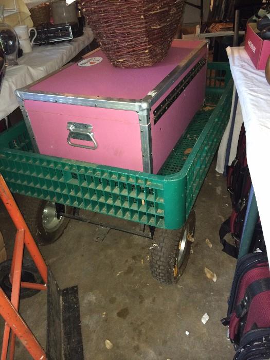 Garden utility cart; pink trunk waiting for a camper