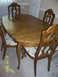 Dining table with 6 chairs, 2 leaves & pads.