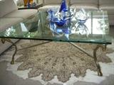 Glass top metal base coffee table on a lovely woven rug