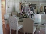 Glass top dining table with eight upholstered chairs