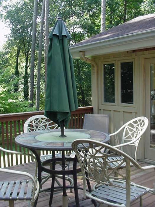 Patio set with four aluminum chairs, umbrella and tile top table