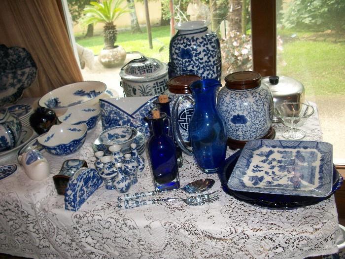 we have three tables filled with blue and white plus a huge set of "Blue Willow" dishware