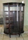 Antique oak mirror back bow front china cabinet. Small crack at rear top of one side panel. Feet are old replacements that look and work fine