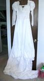 Beautiful wedding dress and veil, never worn, size 10-12. Also have another lovely wedding dress, professionally cleaned and stored, size 4-6, and three black bridesmaids dresses (never worn).