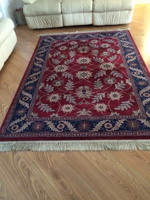 5 x 7 1/2' fringed Oriental rug with skid mat
