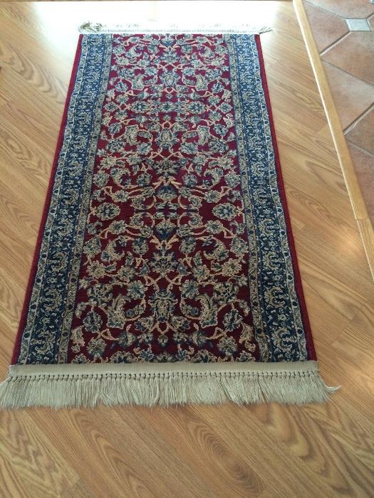 2 1/2 x 5' fringed Oriental area rug with skid mat