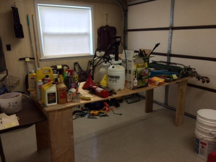 Several sprayers, oil, other garden/lawn sprays, golf clubs with stand, painting supplies, and fire extinguisher.