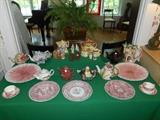 Dining Room:  A collection of tea pots and pink ceramic dishes.