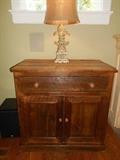 Hearth Room:  One of two custom made pine chests by OLDE ENGLISH LIVING.  Each one measures:  43" wide x 23" deep x 42" tall.  The top drawer drops down while the doors open to one shelf.  Each chest is individually priced.  On top of each chest is a cream color lamp with burlap shade; each priced individually. 